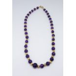 A single row amethyst bead necklet, comprising slightly graduated cabochon round amethyst stones