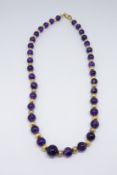 A single row amethyst bead necklet, comprising slightly graduated cabochon round amethyst stones