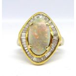 A large opal and diamond cluster ring, of similar design to lot 66 the opal approx. 15mm x 9mm,