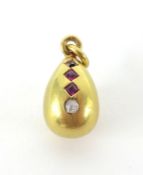 An 18ct ruby and diamond egg pendant.