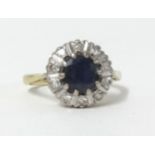 An 18ct sapphire and diamond cluster ring, size K.