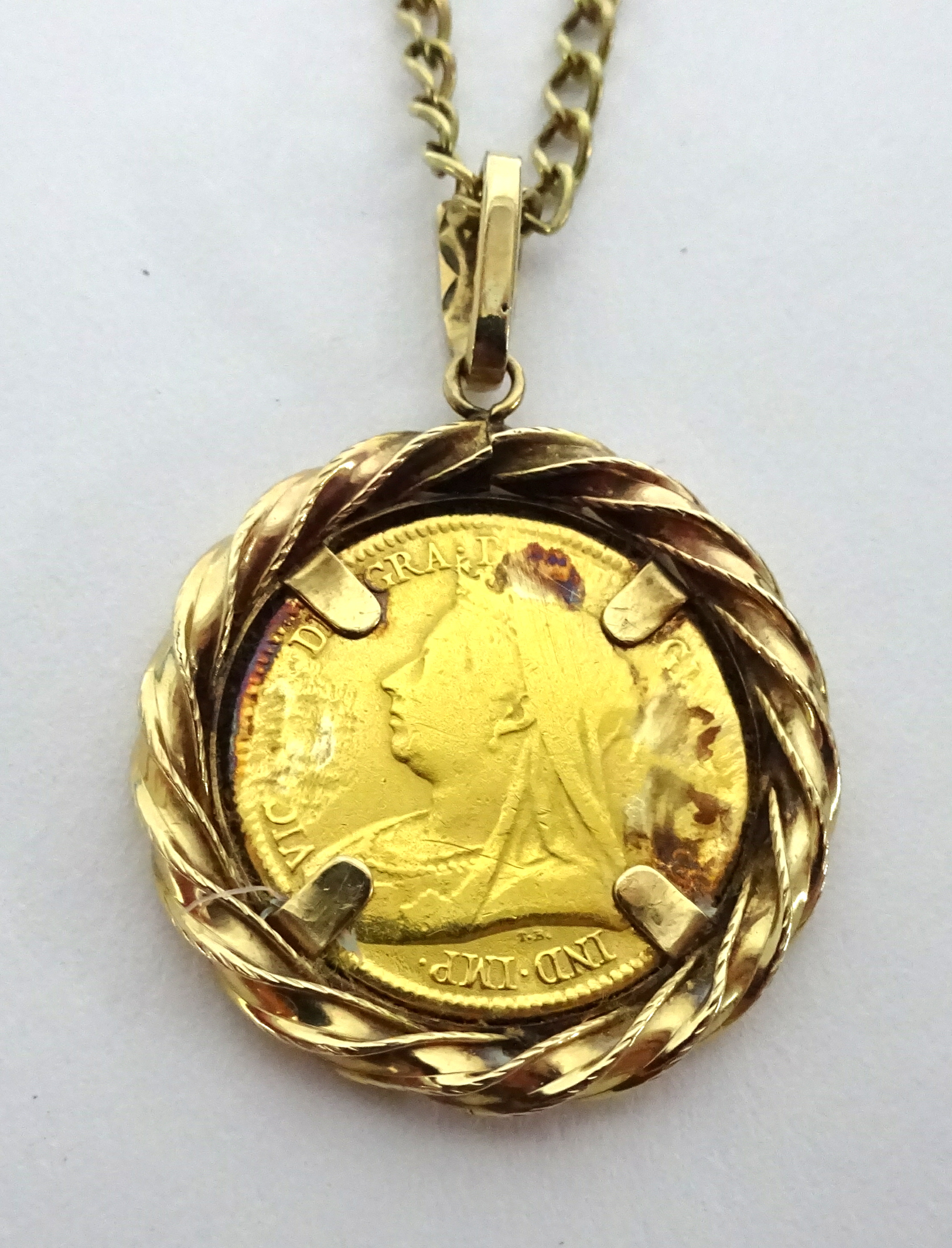 A Victoria 1893 half sovereign set on a 9ct gold chain, total weight 11.20g.