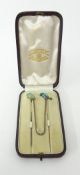 A parrot and beetle stick pin set with gold and turquoise in a Garrard box.