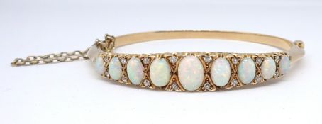 An antique yellow gold open diamond half snap hinged set bangle, possibly 15/18ct gold, set with