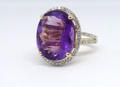 A 14ct yellow gold and diamond ring, set with an oval cut purple amethyst, approx. 6.92carat,