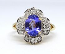 An 18ct tanzanite and diamond cluster ring, size N.
