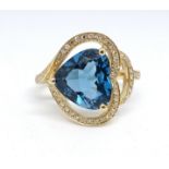A 14ct yellow gold and diamond ring, set with a heart shaped blue topaz, approx. 3.54carat,
