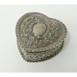 A George V silver box, heart shaped with embossed decoration.