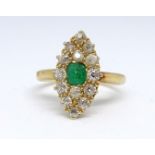An 18ct emerald and diamond oval cluster ring, size J.