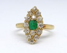 An 18ct emerald and diamond oval cluster ring, size J.