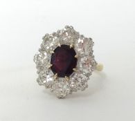 A good 18ct ruby and diamond cluster ring with central ruby stone and eight surrounding diamonds,