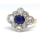 A sapphire and diamond cluster ring formed in a diamond shape, comprising central oval blue