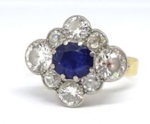 A sapphire and diamond cluster ring formed in a diamond shape, comprising central oval blue