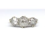 A white gold and platinum set diamond three stone ring, set with old cut diamonds approx. total