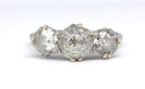 A white gold and platinum set diamond three stone ring, set with old cut diamonds approx. total