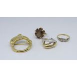 An 18ct three stone diamond ring, a dolphin pendant, a 14ct dolphin dress ring, and a 9ct smoky