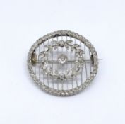 A platinum and diamond set circular brooch, diameter approx. 31mm.