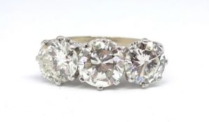 An 18ct fine diamond three stone ring, set with approx. 4 carats of diamonds, shank marked LJW, size