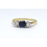 An 18ct sapphire and diamond three stone ring, size N.