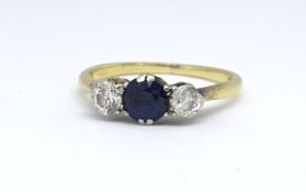 An 18ct sapphire and diamond three stone ring, size N.