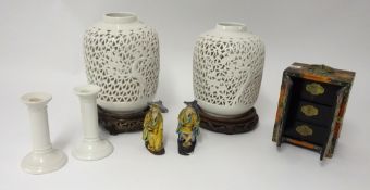 A 20th century Chinese table cabinet, a pair of pierced modern oriental jars and stands, carved