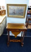 A Victorian rosewood and inlaid work table on barley twist legs.