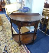 An oak 'demi lune' hall table, fitted with a drawer.