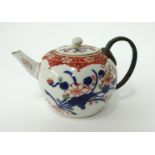An Chinese porcelain 'bullet' shaped teapot with bronze handle, height 11cm.