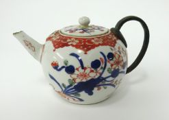 An Chinese porcelain 'bullet' shaped teapot with bronze handle, height 11cm.