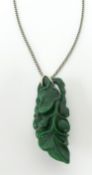 A carved green Jade pendant and chain, height 60mm.