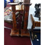 A pair of reproduction carved mahogany torcheres, height 116cm.