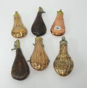 A collection of six 19th century powder flasks in copper and leather.