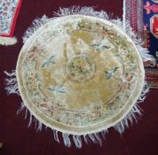 A 20th century Chinese circular silk rug, 37 inches diameter, together with Karajan or Kazak rug