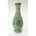 A Japanese celadon porcelain bottle vase decorated in enamels of flowers and cranes, height 19cm.