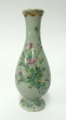 A Japanese celadon porcelain bottle vase decorated in enamels of flowers and cranes, height 19cm.