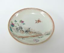 A Chinese porcelain circular shallow dish decorated with ducks and flowers (old repair), diameter