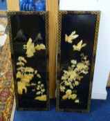 A pair of oriental lacquered wall panels decorated in relief with landscape, birds and flowers, 92 x