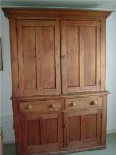 An old pine housekeepers cupboard, upper section fitted with two cupboards, the base fitted with two