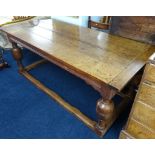 An antique oak refectory dining table, four plank top over a base with four bulbous carved legs