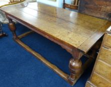 An antique oak refectory dining table, four plank top over a base with four bulbous carved legs