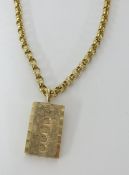 A 9ct gold ingot on yellow metal necklace unmarked, possibly 9ct, total weight 19.20g.