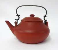 A Yixing teapot of squat form, with brass handle, height 10cm, impressed marks.