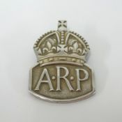 A silver ARP badge.