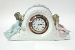 Lladro, a porcelain mantle clock, width 33cm.