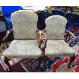 A pair of mahogany framed elbow chairs with upholstered seats and backs of Georgian design.