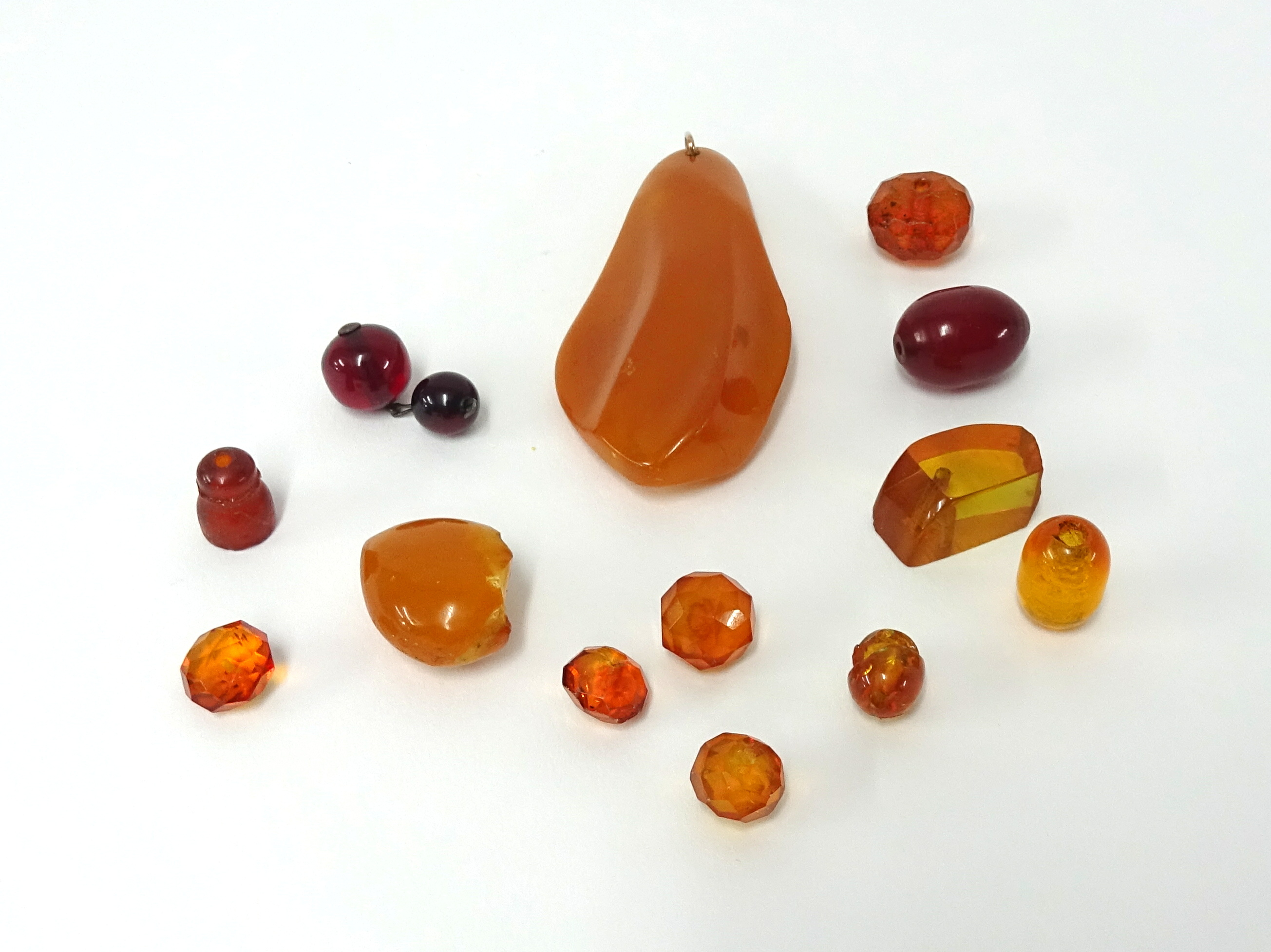 A small collection of amber pendants and stones.