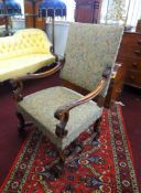 An 18th century style walnut framed open elbow chair with upholstered seat.