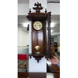 A Victorian Vienna style walk clock with two train movement, in a carved mahogany case, mounted with