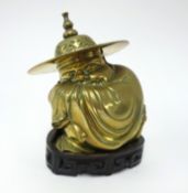 A Chinese brass figure squatting man, on hand carved stand, total height 19cm.