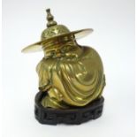 A Chinese brass figure squatting man, on hand carved stand, total height 19cm.